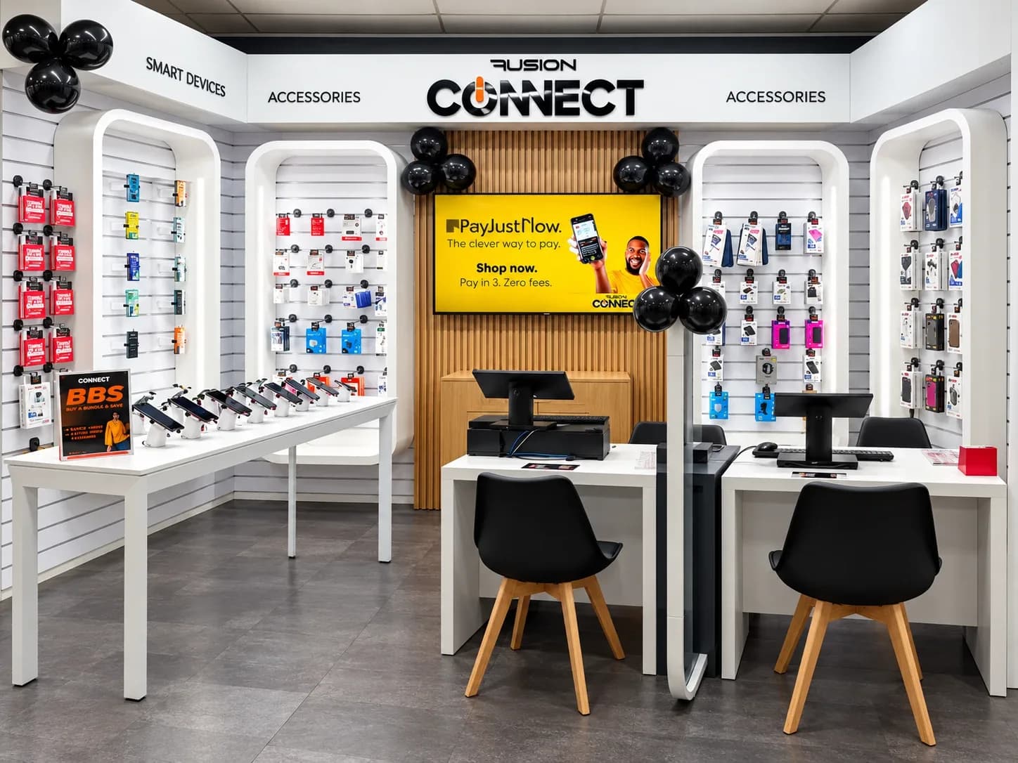 The Fusion Connect kiosk: white display walls of phone accessories, a phone demo table and two service desks under the Fusion Connect sign